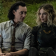 Tom Hiddleston's Loki wears a dirty shirt and tie while sitting next to Sophia Di Martino's Sylvie in her supersuit on the ground.